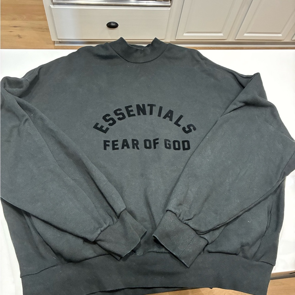This is a Fear of God Essentials black sweatshirt.